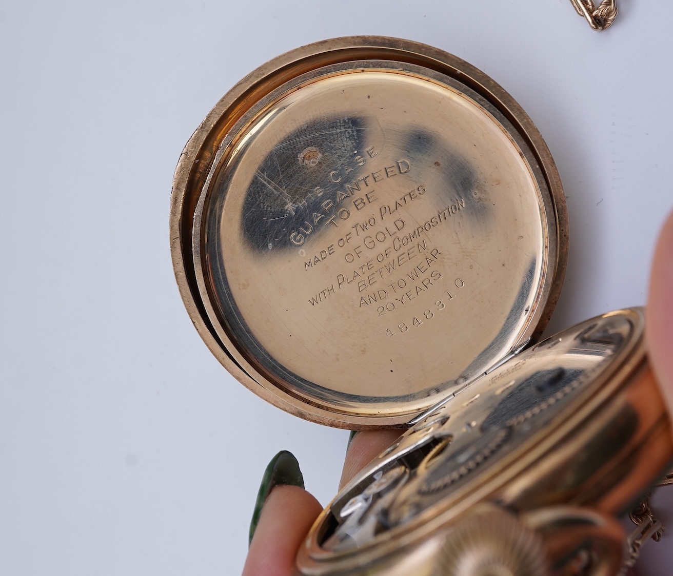 An amethyst fob seal, a gold Albert chain, and a pocket watch